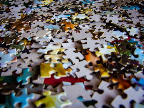 Colorful jigsaw puzzle pieces spread on a table.